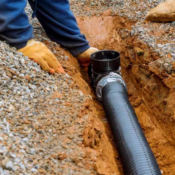 Laying underground drain pipes